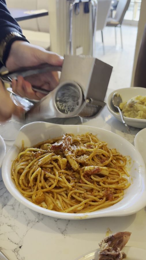 파스타에 치즈를 뿌리는 모습