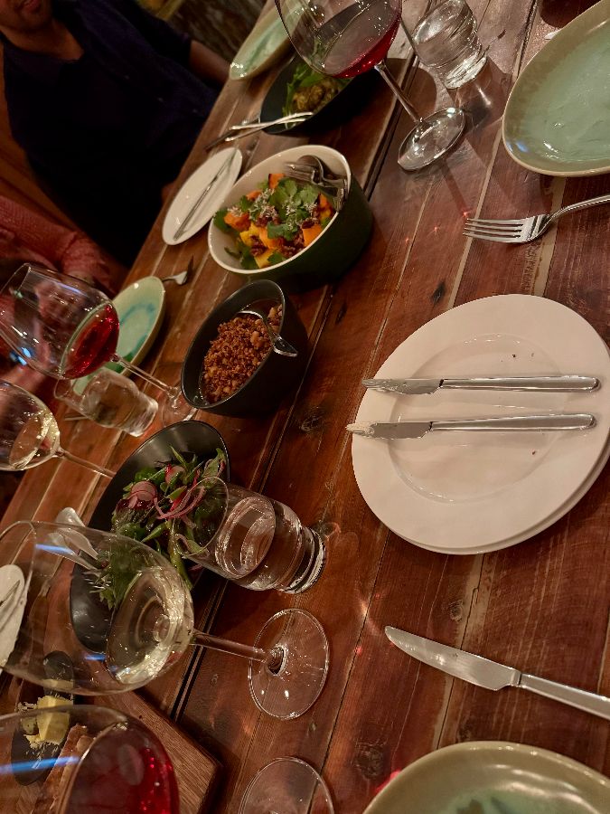 테이블 위에 놓인 음식 사진. 다양한 종류의 음식과 와인잔이 보인다.